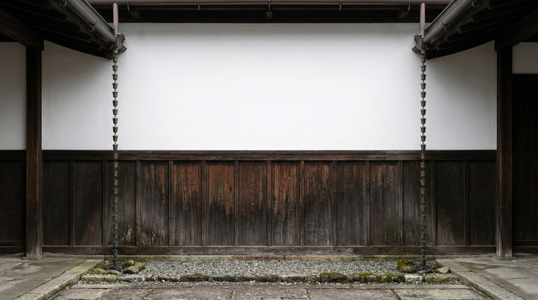 Japanese two-tone facade — white plaster above, dark wood below, copper rain chains